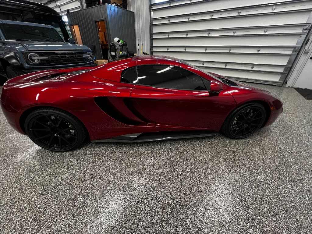 Red McLaren side profile in Doctor Detail garage — Eagan MN