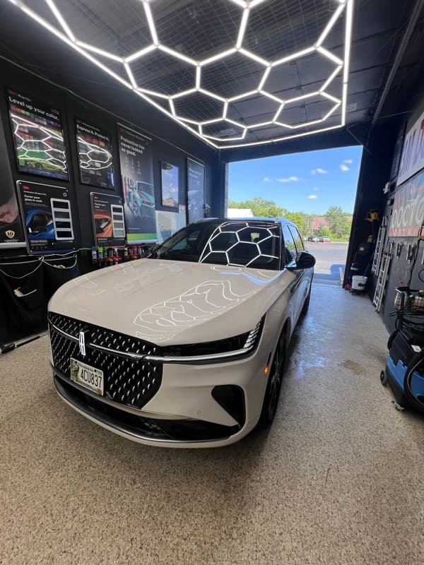 White Lincoln SUV in Doctor Detail shop — Eagan MN